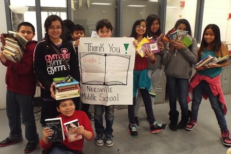 NMS youth with books and thank you sign